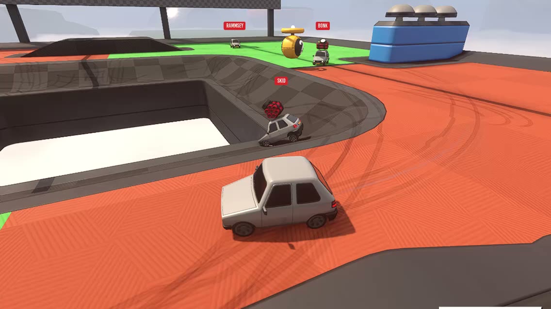 Cars battling around a pit in a Sumo Cars arena